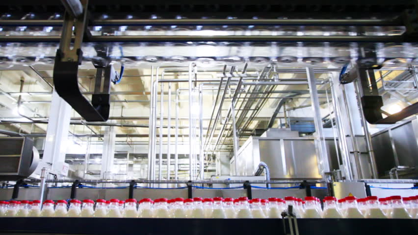 bottom row plastic bottles with milk and top of empty move at factory