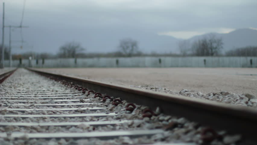 Walking to the unknown - Man walking on train tracks