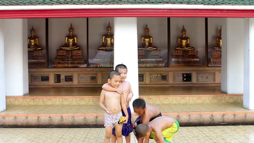 BANGKOK - 20 OCTOBER 2011:  Children and Golden Buddha Statues