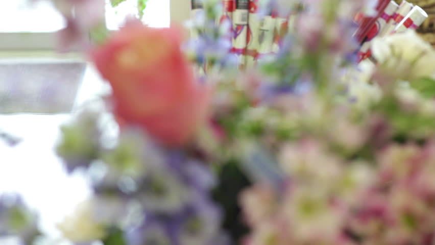 Series of three shots showcasing an arrangement of pink purple and white flowers for valentines day
