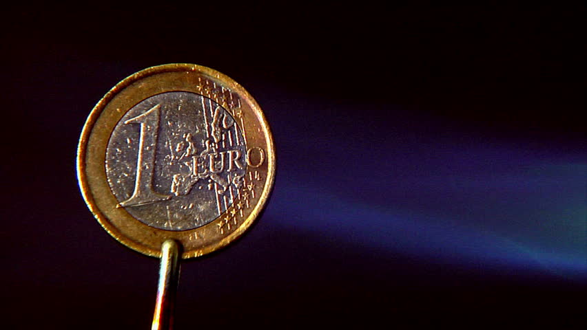 Metaphor about European Financial Crisis: Euro coin in a fireball starts glowing.