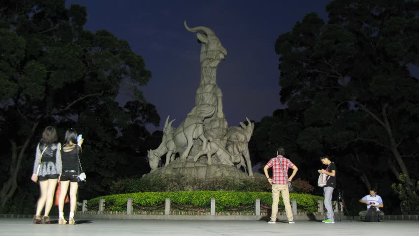 GUANGZHOU - NOV 24: (Timelapse View) Tourists are taking photographs near the Sculpture of Five Rams at night, on Nov 24, 2011 in Guangzhou, Guangdong, China 