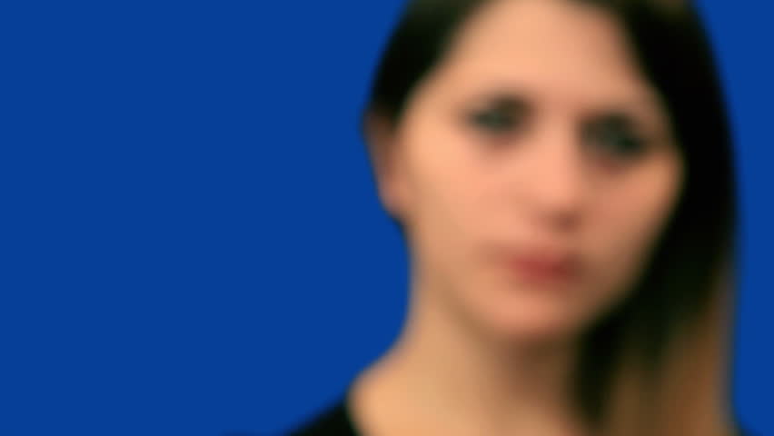 Blue screen beautiful girl try to hear close up