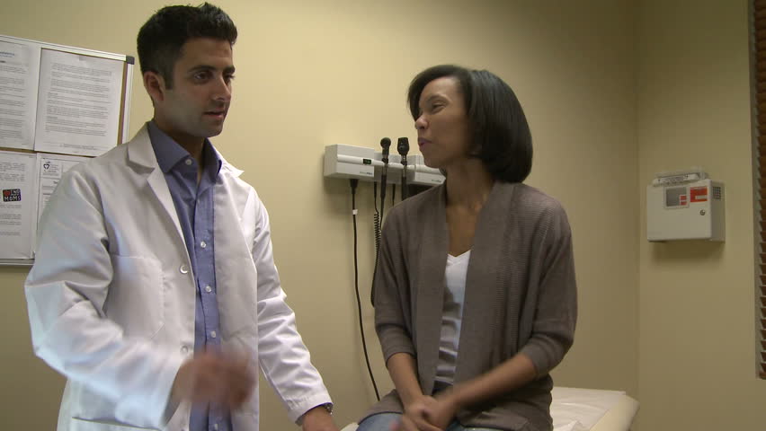Doctor in exam room with female patient