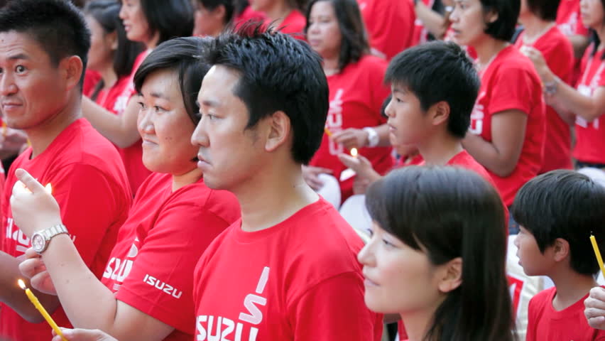 BANGKOK - JANUARY 24, 2012: People are singing during the Chinese New Year celebration in Bangkok Chinatown. Part of the event is sponsored by Isuzu. 