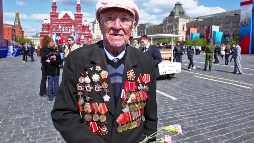 MOSCOW - MAY 9: Veteran Andrey Mehailovich speak about war at background of Kremlin wall on May 9, 2011 in Moscow, Russia.