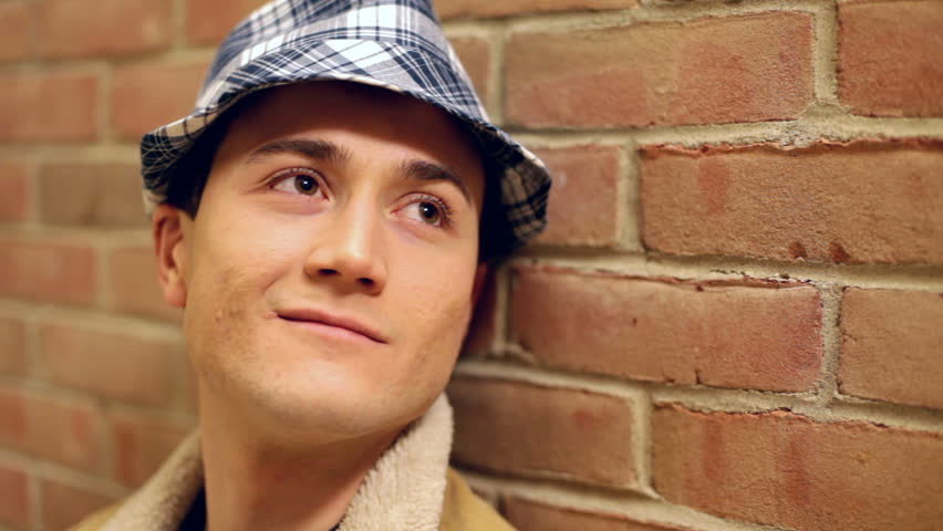 Male looking up daydreaming with hat