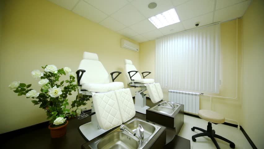 In cosmetology room for pedicure in beauty salon there are two special seats also there are flowers