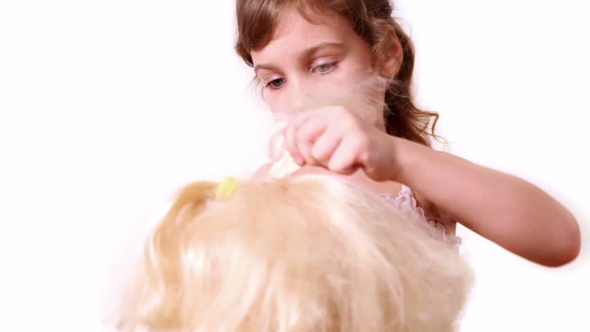 Little girl braids dolls hair, isolated on white background