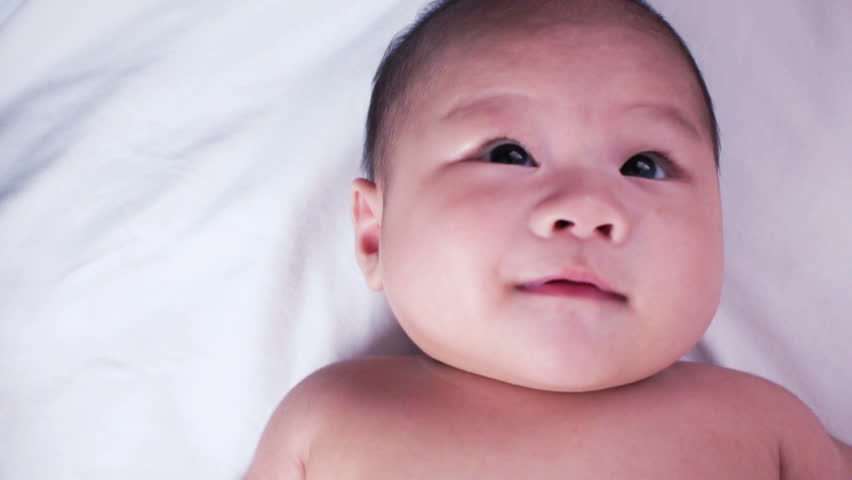 A cute little baby being tease by father