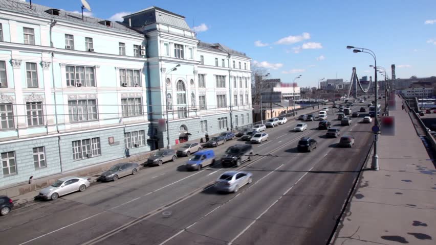 Lot of cars ride to Crimean Bridge in Moscow at sunny winter day