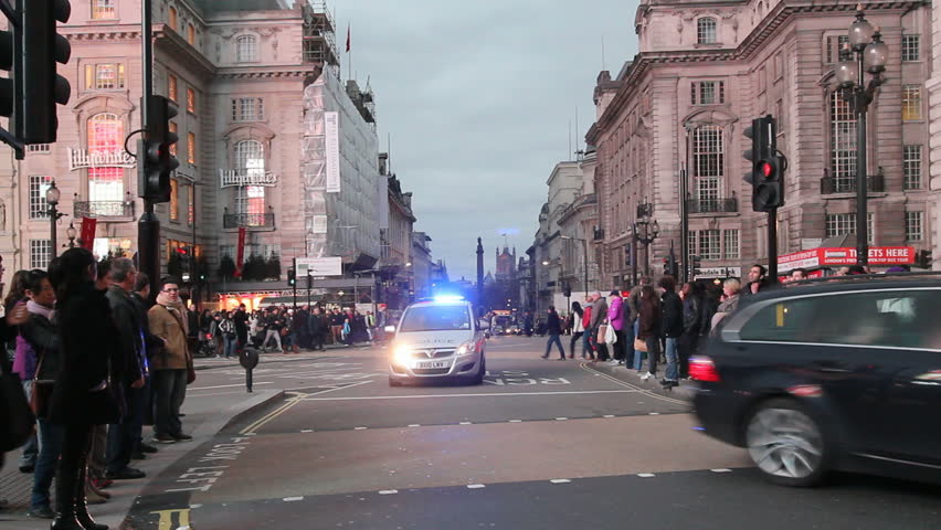 LONDON, UK - DECEMBER 27: Police car with siren speeds on Piccadilly Circus on December 27, 2011 in London, UK. Piccadilly Circus is one of the main entertainment areas of London.