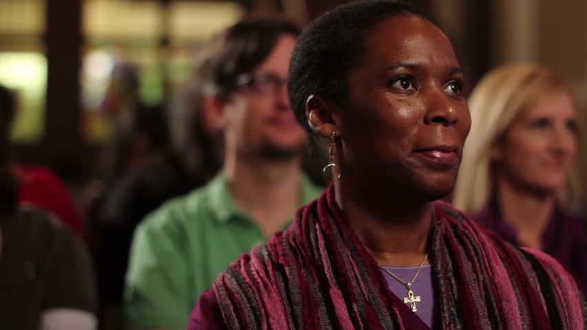 African American Woman sitting in a pew at church