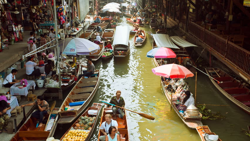 DAMNOEN SADUAK, THAILAND - FEBRUARY 25: Tourists are doing boat rides at the Damnoen Saduak Floating Market on February 25, 2012 in Damnoen Saduak, Thailand.
