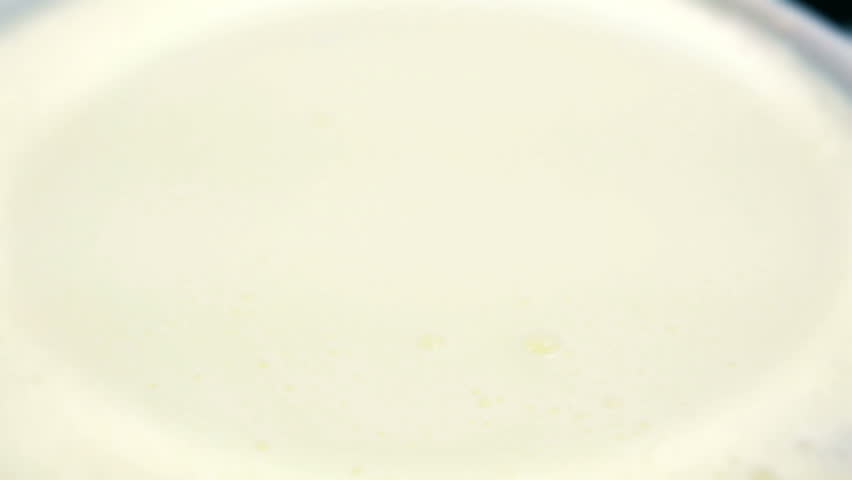 Cornflakes falling into yogurt.