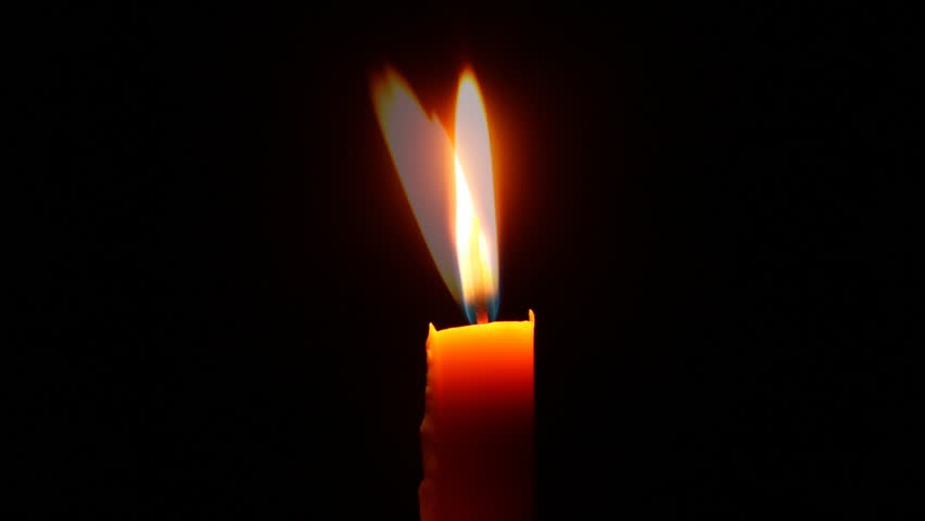 Candlelight in the dark background, time-lapse.