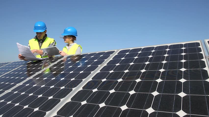 Engineers working on solar panels plant