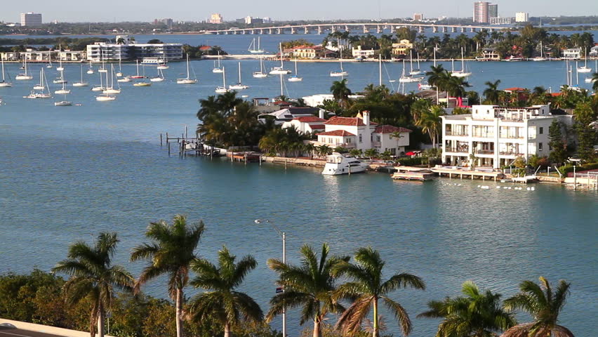 sailboats in miami bay area on a beautiful summer day, aerial view, near star island mansions