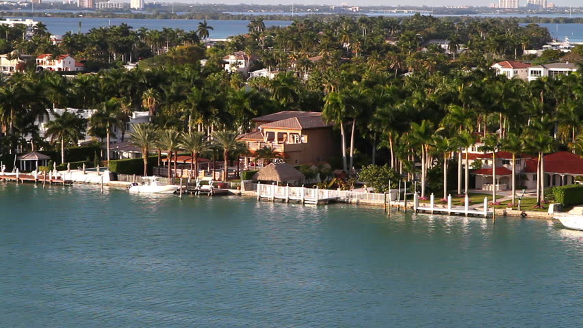 sailboats in miami bay area on a beautiful summer day, aerial view, near star island mansions