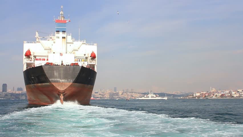 Large ship sailing through Straits in Istanbul, Turkey. Back view of the oil tanker ship
