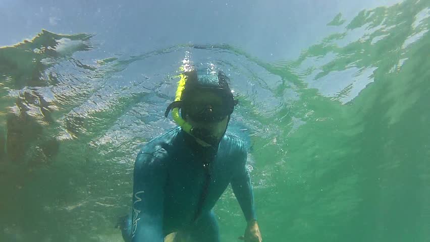 Snorkeler giving thumbs up in marine reserve Goat Island in New Zealand.