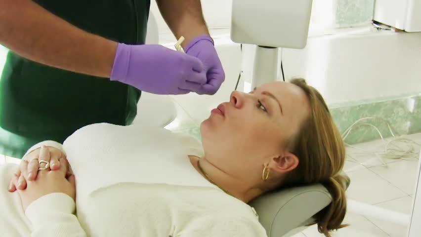 Dentist Lateral Xray Machine (HD). Dentist X-Ray machine shot with logos carefully taken out with rotoscoping and masking. X-Ray machine emits radiation to the camera when exposed.