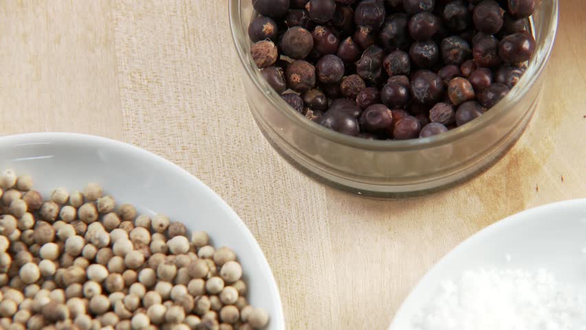 Dishes of white peppercorns and juniper berries
