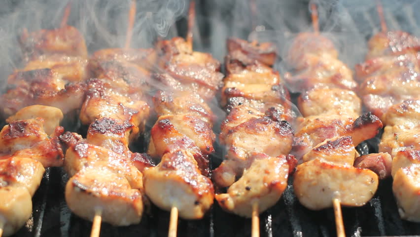 Barbecue With Delicious Grilled Meat On Grill.  
 Chicken meat pieces being fried on a charcoal grill .