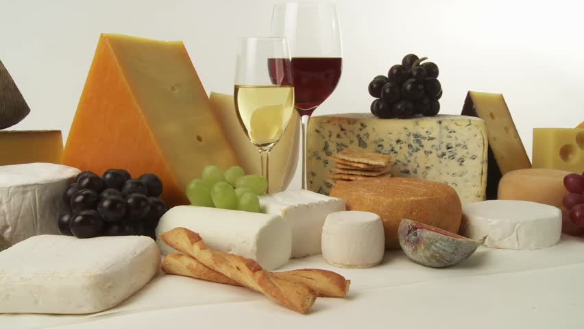 Various cheeses with wine, grapes and savoury biscuits