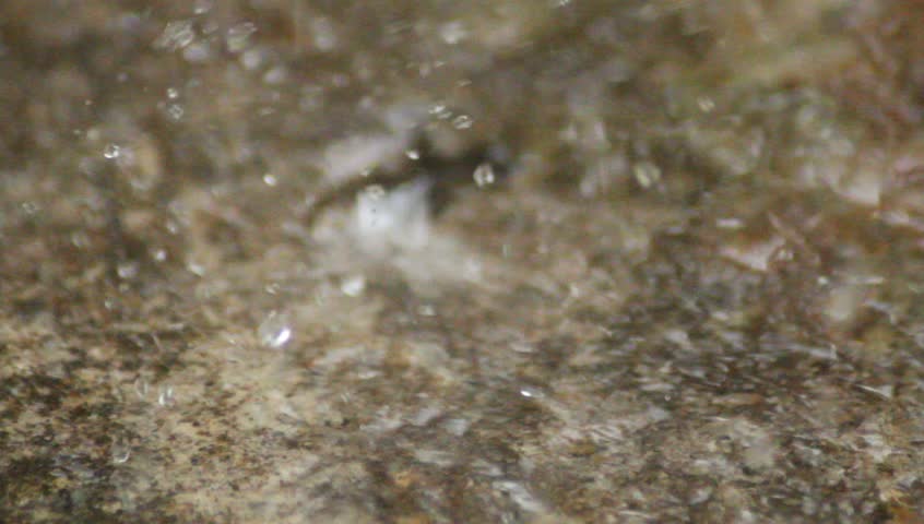Rain falling on pavement