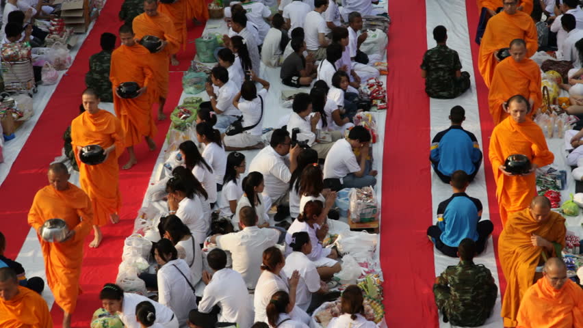 BANGKOK - MARCH 18: Monks are participating in a Mass Alms Giving of 12,600 monks in Central World for the Makha Bucha celebrations on March 18, 2012 in Bangkok, Thailand.