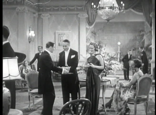 Waiter serving champagne to guests at party
