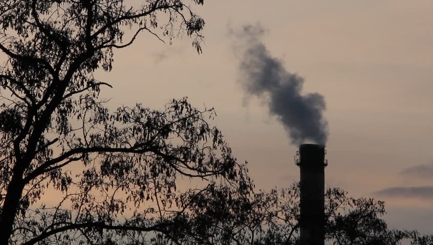 Smoke spews from an industrial smokestack
