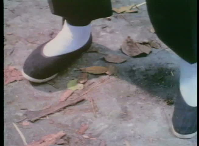 Close-up of feet in Chinese slippers practicing martial arts moves