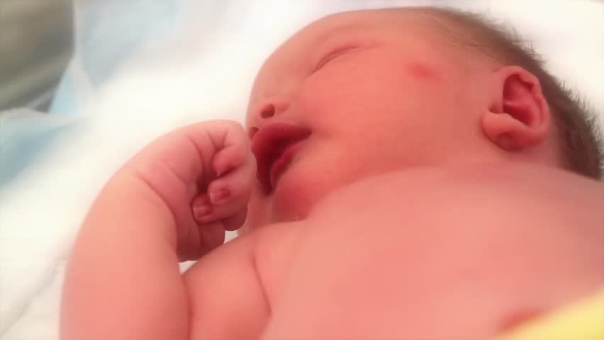 A newborn baby at the hospital born just minutes before being cleaned by the nursing staff.