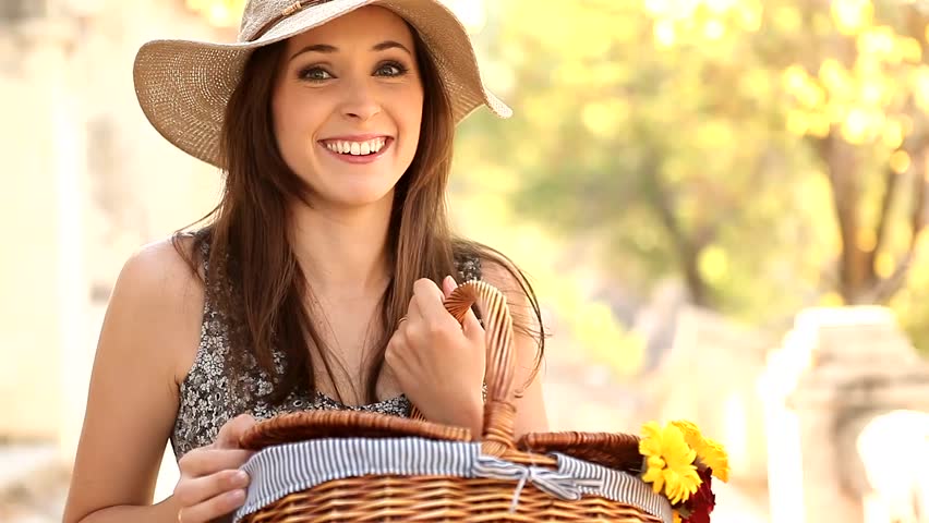 Young curious woman looking into her picnic basket