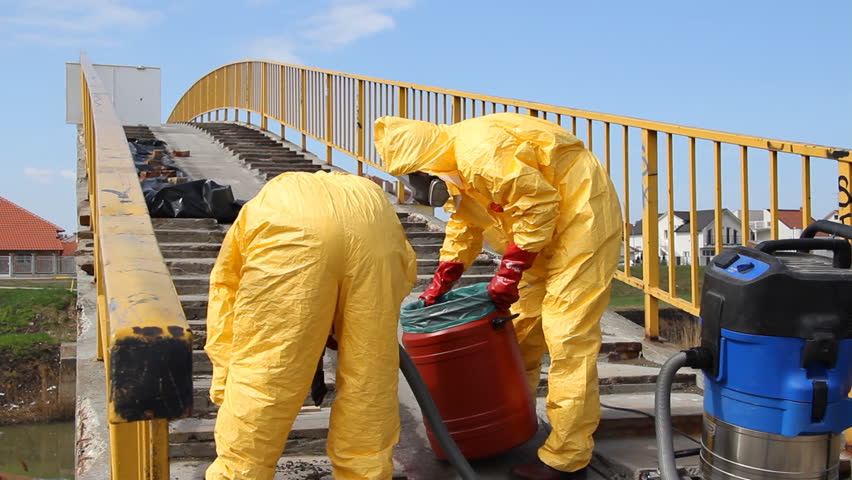 Professional  people in protective uniform removing of chemicals and dangerous materials