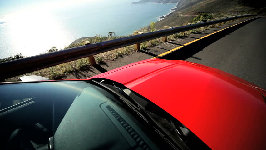 Driving on a winding highway following the California coastline