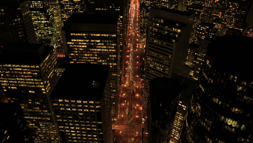 Aerial night illuminated view of skyscrapers, rooftops and city streets, North America, USA