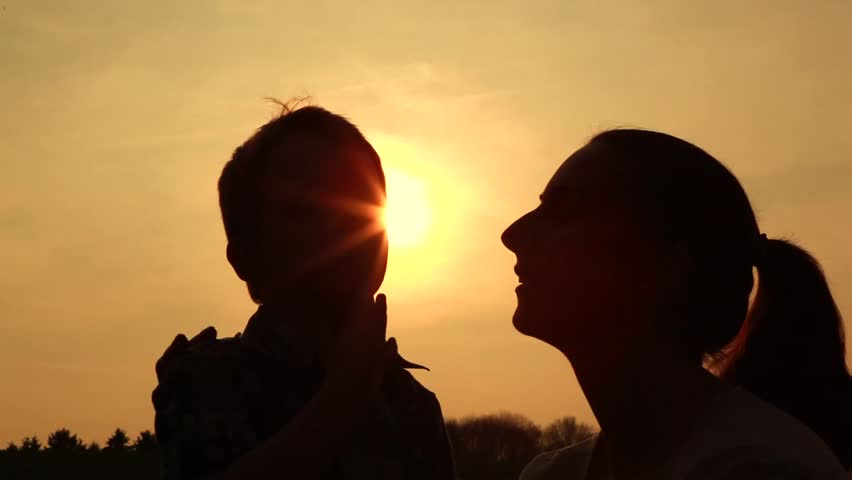 mother loving her son, silhouetted
