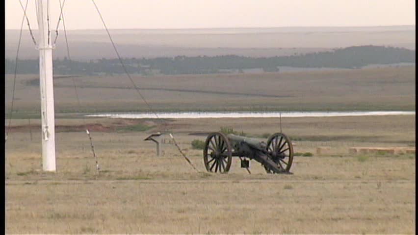 A smooth zoom out from and then back in to the Civil War Cannon on the parade grounds of old Fort Union National Monument, through broken adobe walls.