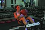 A lovely young bodysculptor does situps with a ball at the gym.