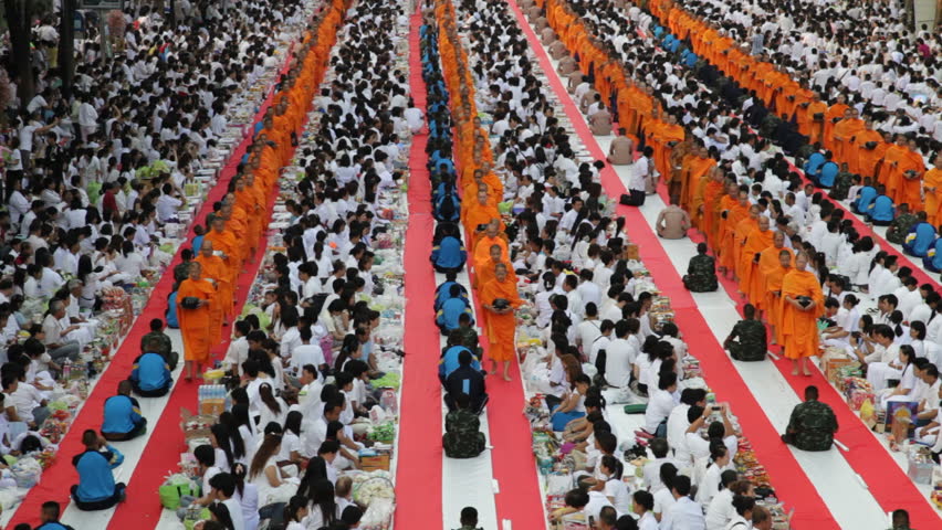 BANGKOK - MARCH 25: Monks are participating in a Mass Alms Giving of 12,600 monks in Central World for the Makha Bucha celebrations on March 25, 2012 in Bangkok, Thailand.