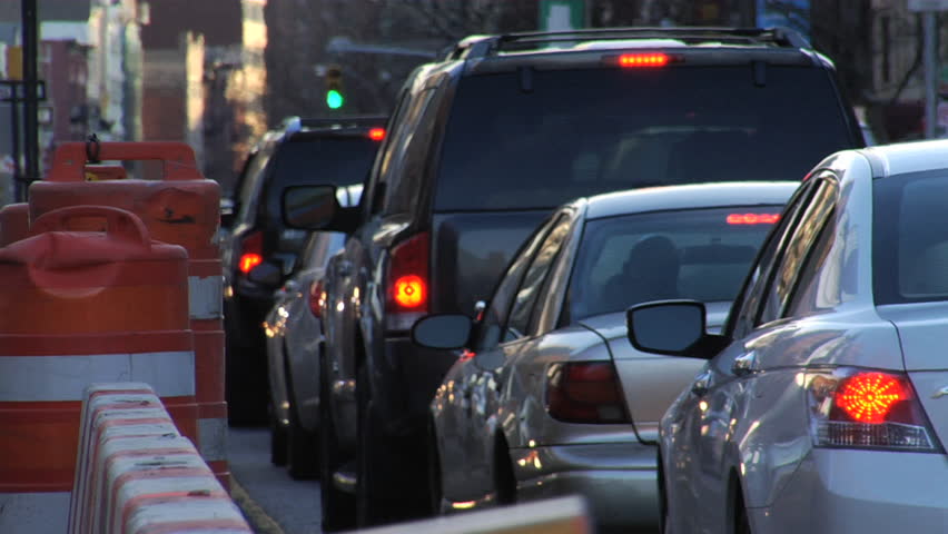 Traffic jam moves slowly. Heavy congestion on the lower east side of Manhattan due to construction at dusk. Closeup. 