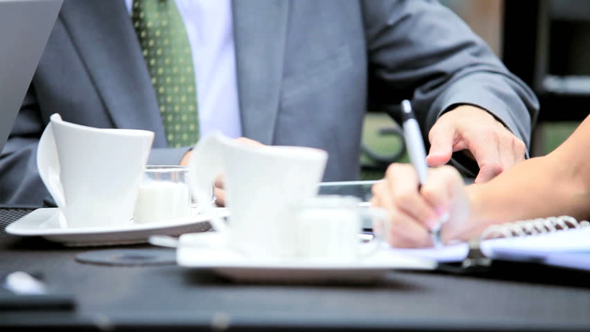 Management people meeting informally at a cafe