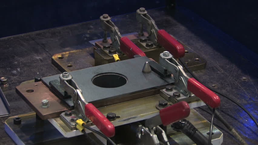Automated Robot Arm Arc Welds Metal in Industrial Production Process