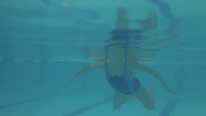 Female swimming in swimming pool in gym