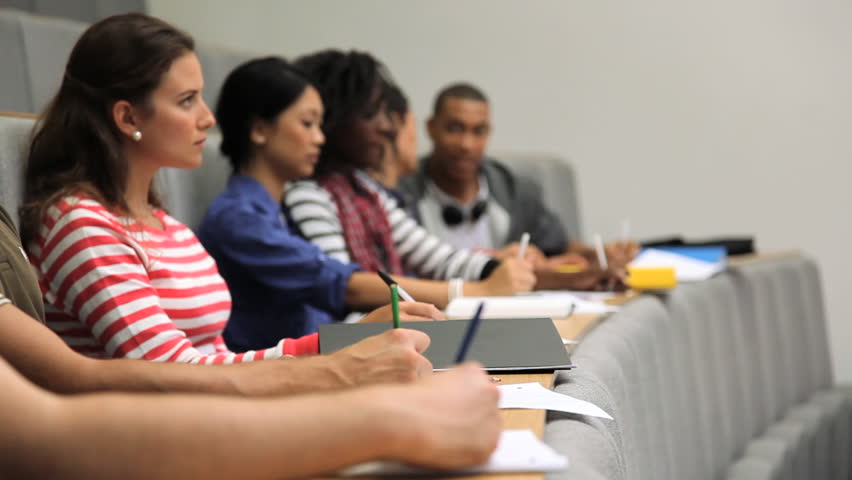 Group of students taking notes in lecture theater