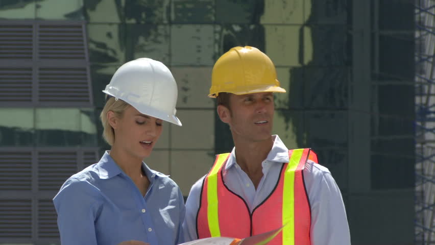 Male and female construction workers on a site