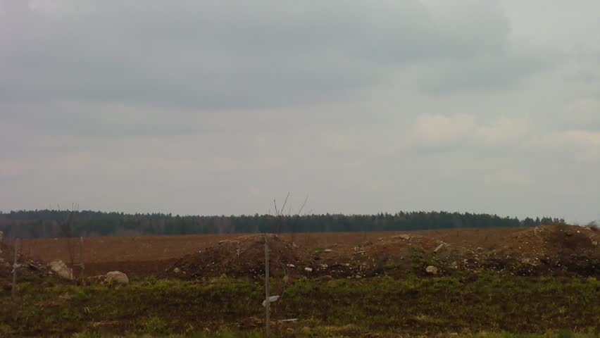 Farmer plowing with tractor in agricultural field